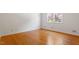 A bright and airy bedroom showcasing beautiful hardwood floors and a large window inviting natural light at 904 Emory Ln, Raleigh, NC 27609