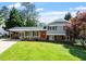Charming two-story home with a lush front lawn, carport, and inviting red front door at 904 Emory Ln, Raleigh, NC 27609