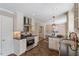 Modern kitchen featuring stainless steel appliances, granite countertops, and custom cabinetry at 904 Emory Ln, Raleigh, NC 27609