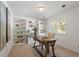 Bright home office with built-in bookshelves and a wooden desk illuminated by natural light from a nearby window at 904 Emory Ln, Raleigh, NC 27609