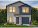 Charming two-story home featuring mixed siding and a two-car garage, surrounded by lush landscaping and trees at 99 Landon Pl, Roxboro, NC 27573