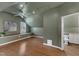Well-lit attic bedroom features hardwood floors, recessed lighting, a ceiling fan, and an en suite bathroom at 1005 Thorncroft Ln, Apex, NC 27502