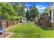 Large backyard features a well-maintained lawn, a storage shed, privacy fence, and access to the home at 1005 Thorncroft Ln, Apex, NC 27502