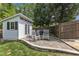 Backyard shed features double doors and is complemented by a seating area for outdoor enjoyment at 1005 Thorncroft Ln, Apex, NC 27502