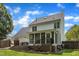 Spacious backyard with a deck, screened-in porch, and well-maintained lawn at 1005 Thorncroft Ln, Apex, NC 27502