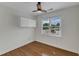 Bedroom featuring hardwood floors, a window with a view, and a mounted storage cabinet at 1005 Thorncroft Ln, Apex, NC 27502