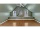 Angled bonus room featuring a window bench, hardwood floors, ceiling fan, and a contemporary painting at 1005 Thorncroft Ln, Apex, NC 27502