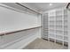 Walk-in closet with carpet, featuring shelves and clothing rods for ample storage space, and a built-in unit at 1005 Thorncroft Ln, Apex, NC 27502