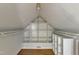 A walk-in closet with built-in shelving offers ample storage space in a well-lit attic at 1005 Thorncroft Ln, Apex, NC 27502