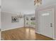 Bright entryway featuring hardwood floors, a chandelier, and a view of the front yard at 1005 Thorncroft Ln, Apex, NC 27502