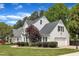 Well-maintained home with attached garage, lush trees, and well manicured landscaping at 1005 Thorncroft Ln, Apex, NC 27502
