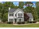 Charming two-story home with a well-manicured lawn and mature trees at 1005 Thorncroft Ln, Apex, NC 27502