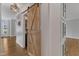 Hallway featuring hardwood floors, a barn door, and built-in storage cabinets at 1005 Thorncroft Ln, Apex, NC 27502