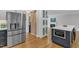 Well-equipped kitchen with stainless steel refrigerator, a barn door, and an island with bar seating at 1005 Thorncroft Ln, Apex, NC 27502