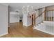 Open living space with fireplace, staircase, and barn door offering a blend of classic and modern elements at 1005 Thorncroft Ln, Apex, NC 27502