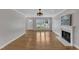 Bright living room with hardwood floors, a fireplace, and large windows for natural light at 1005 Thorncroft Ln, Apex, NC 27502