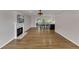 Spacious living room featuring hardwood floors, fireplace, and access to the screened-in porch at 1005 Thorncroft Ln, Apex, NC 27502