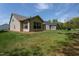 Exterior view of the home and manicured backyard with healthy green grass at 1007 Fairhaven Dr, Mebane, NC 27302