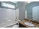 Bathroom with granite countertop vanity and a tub with a shower fixture showcasing its features at 1007 Fairhaven Dr, Mebane, NC 27302