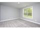 Neutral bedroom with a large window allowing plenty of natural light at 1007 Fairhaven Dr, Mebane, NC 27302