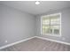 Neutral bedroom with carpet and a large window allowing natural light to flood the room at 1007 Fairhaven Dr, Mebane, NC 27302
