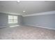 Expansive bonus room featuring plush carpeting and abundant natural light through a window at 1007 Fairhaven Dr, Mebane, NC 27302
