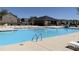 Large community swimming pool features stairs, safety markers, and chairs for resident use at 1007 Fairhaven Dr, Mebane, NC 27302