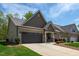 Charming home with a brick and shingle facade, manicured lawn, and a two-car garage in a suburban setting at 1007 Fairhaven Dr, Mebane, NC 27302