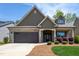 Charming home with brick and shingle exterior, a well-kept lawn and a two car garage at 1007 Fairhaven Dr, Mebane, NC 27302