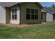 Exterior of home with trimmed green grass, brown mulch, and views of other homes at 1007 Fairhaven Dr, Mebane, NC 27302