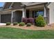 Charming home featuring lush landscaping, a brick facade, and a covered front porch with elegant white columns at 1007 Fairhaven Dr, Mebane, NC 27302