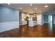 Open-concept kitchen with stainless steel appliances, marble countertops, island, and hardwood floors at 1007 Fairhaven Dr, Mebane, NC 27302