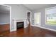 Cozy living room with a fireplace, staircase, and outdoor access at 1007 Fairhaven Dr, Mebane, NC 27302