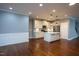 An open-concept living space featuring modern kitchen and large living room with hardwood flooring and natural light at 1007 Fairhaven Dr, Mebane, NC 27302