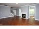 Spacious living room with a fireplace, staircase, and hardwood floors at 1007 Fairhaven Dr, Mebane, NC 27302