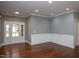 An open-concept living room featuring hardwood floors, recessed lighting, and classic white trim on wainscoting at 1007 Fairhaven Dr, Mebane, NC 27302