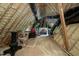 Unfinished attic featuring exposed rafters, insulation, and potential for storage space at 1009 Linenhall Way, Wake Forest, NC 27587
