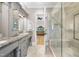 Elegant bathroom features dual vanities, granite countertops, and a beautifully tiled shower at 1009 Linenhall Way, Wake Forest, NC 27587
