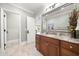 Well-lit bathroom features a single vanity with granite countertops and a large decorative mirror at 1009 Linenhall Way, Wake Forest, NC 27587
