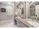 Elegant bathroom features dual vanities, granite countertops, and a beautifully tiled shower at 1009 Linenhall Way, Wake Forest, NC 27587