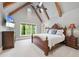 Bright bedroom with vaulted ceilings, exposed beams, and a view of the outdoors at 1009 Linenhall Way, Wake Forest, NC 27587
