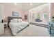 Bright bedroom with elevated seating area, large windows, and a comfortable king-size bed at 1009 Linenhall Way, Wake Forest, NC 27587