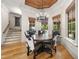Bright breakfast nook features wood floors, a rustic table, unique chairs, and custom wood ceiling detail at 1009 Linenhall Way, Wake Forest, NC 27587