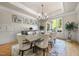 Formal dining room featuring wainscoting, chandelier, and a large window with natural light at 1009 Linenhall Way, Wake Forest, NC 27587