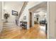 Elegant foyer with hardwood floors, staircase, and views into the living spaces at 1009 Linenhall Way, Wake Forest, NC 27587