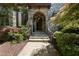 Charming front entrance with stone archway, steps, and landscaped garden beds leading to front door at 1009 Linenhall Way, Wake Forest, NC 27587