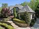 Beautiful front yard with manicured landscaping, stone accents, and a charming walkway at 1009 Linenhall Way, Wake Forest, NC 27587