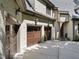 Spacious three-car garage with classic wooden doors and ample parking on a wide concrete driveway at 1009 Linenhall Way, Wake Forest, NC 27587