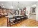 Spacious kitchen with an island, seating, hardwood floors, and custom lighting at 1009 Linenhall Way, Wake Forest, NC 27587
