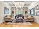 Cozy living room with classic furniture, a patterned rug, and bright natural lighting at 1009 Linenhall Way, Wake Forest, NC 27587